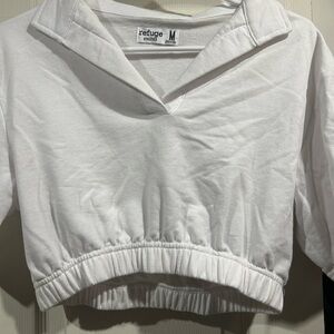 White tennis top. Medium size with low neck.